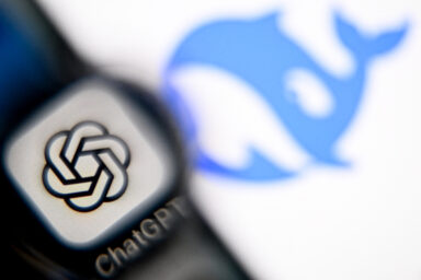 Smartphone displaying the GPT chat logo next to a laptop showing the Deepseek AI logo. (Photo by Kirill KUDRYAVTSEV / AFP)