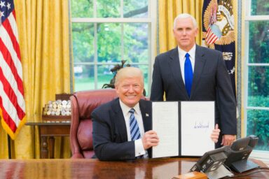 Trump signing a bill in the oval office. Photo: Unsplash