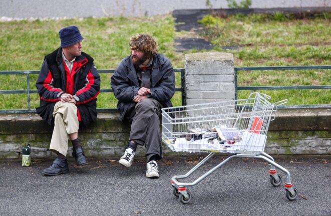 homeless men outside with shopping cart