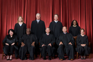 Formal group photograph of the Supreme Court as it was been comprised on June 30, 2022 after Justice Ketanji Brown Jackson joined the Court. The Justices are posed in front of red velvet drapes and arranged by seniority, with five seated and four standing. Seated from left are Justices Sonia Sotomayor, Clarence Thomas, Chief Justice John G. Roberts, Jr., and Justices Samuel A. Alito and Elena Kagan. Standing from left are Justices Amy Coney Barrett, Neil M. Gorsuch, Brett M. Kavanaugh, and Ketanji Brown Jackson. Credit: Fred Schilling, Collection of the Supreme Court of the United States