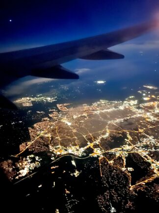 Aerial night view of a European city from a plane window