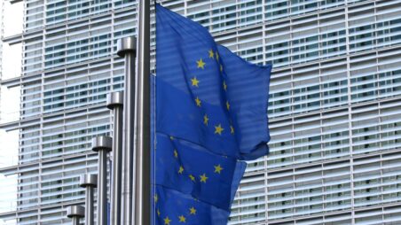 EU flags in front of the Berlaymont building, the seat of the European Commission