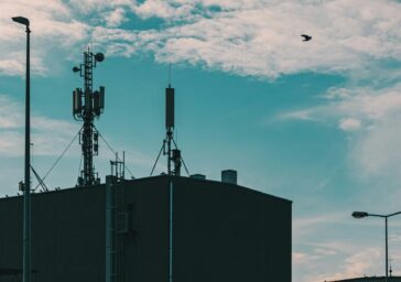 Telecommunications masts against a cloudy sky