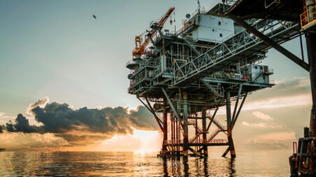 Offshore oil platform at sea under a cloudy sky