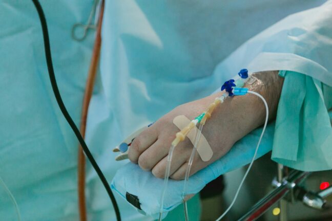 Close-up of a patient’s hand with an intravenous drip attached