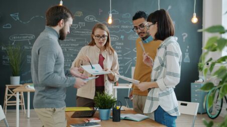 Team of startup founders discussing strategy in a modern office