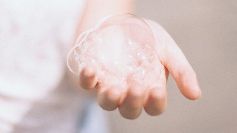 A woman’s hand covered in shampoo foam