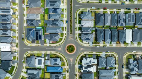 Aerial view of a residential neighbourhood with solar panels on rooftops.
