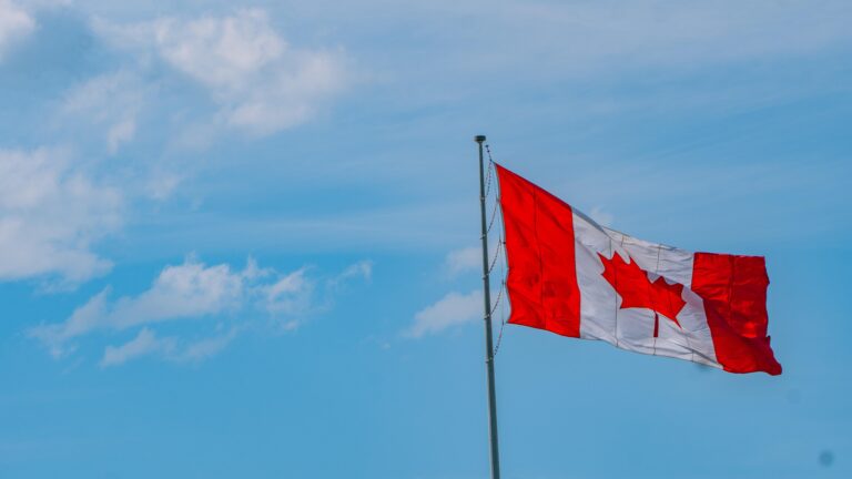 canadian flag against blue sky