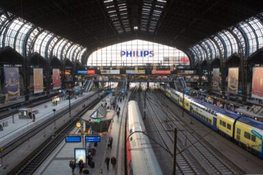 View of a busy European train station with multiple platforms and trains