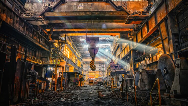 Industrial factory interior with heavy machinery and overhead crane
