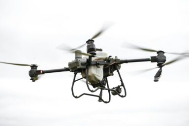 Large industrial drone in flight against a grey sky