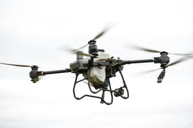 Large industrial drone in flight against a grey sky