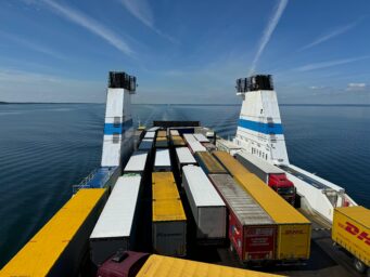 Trucks loaded on a cargo ferry crossing open sea