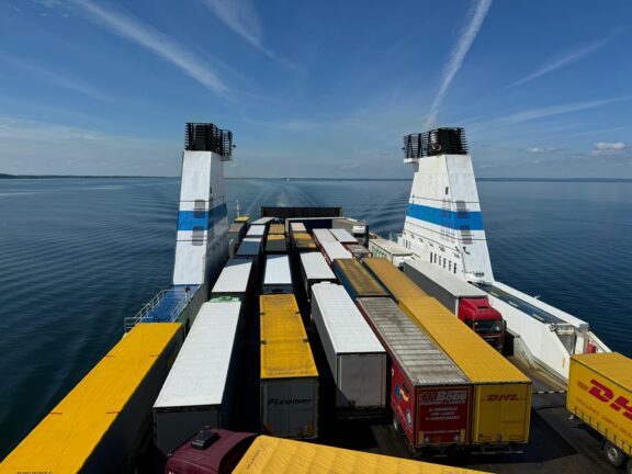Trucks loaded on a cargo ferry crossing open sea