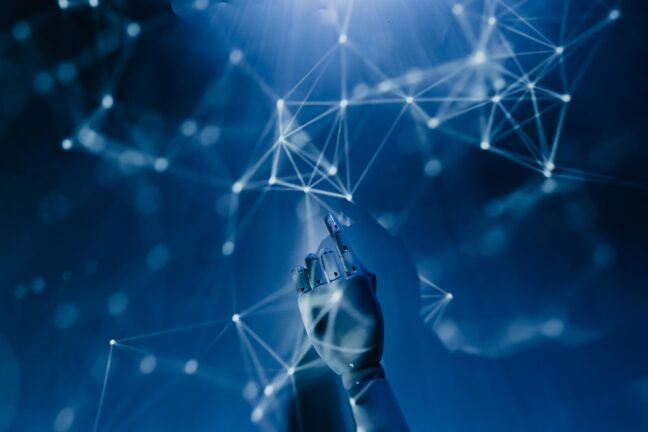 A robotic hand pointing upward toward a digital network