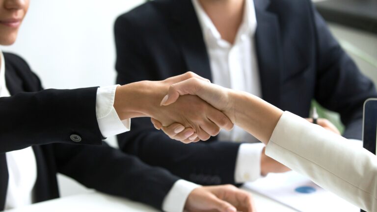 Close-up of two business people shaking hands