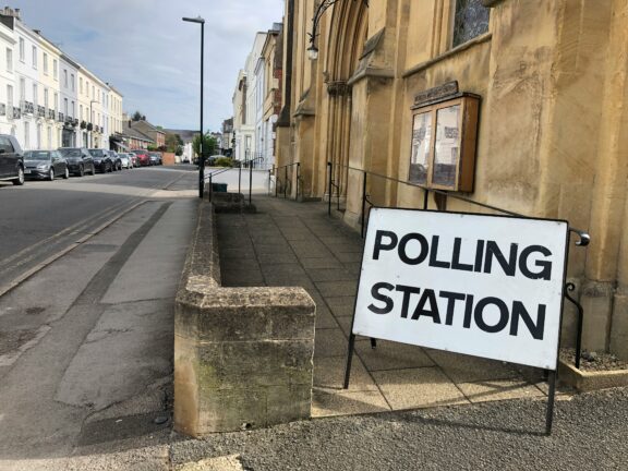 Polling station sign on a quiet street