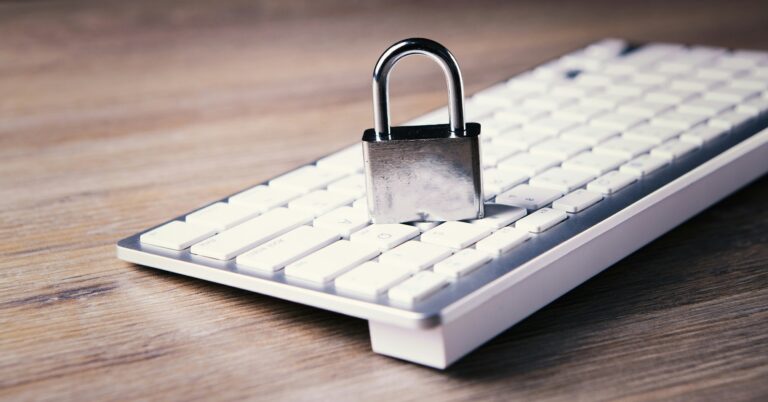 A padlock resting on a computer keyboard