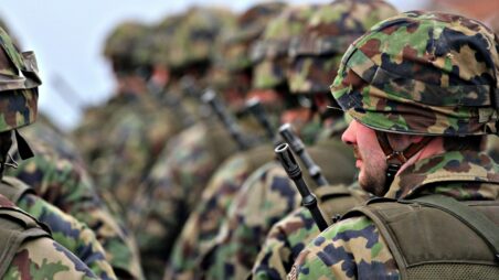 Rows of soldiers in helmets and camouflage uniforms