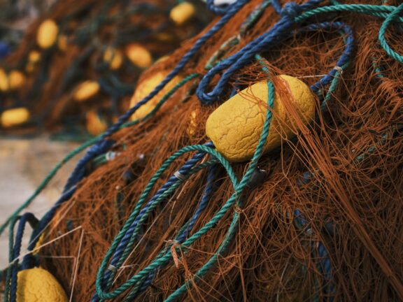 Fishing nets piled up at a harbour