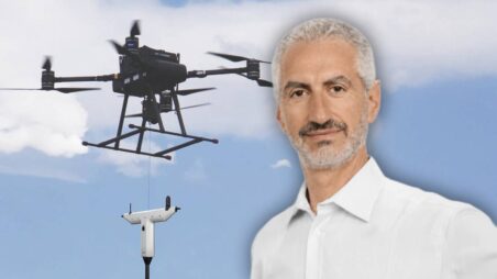 Emmanuel Nabet, with drone against blue sky in the background