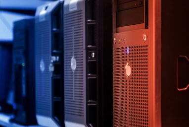 A row of server towers lit in blue and orange