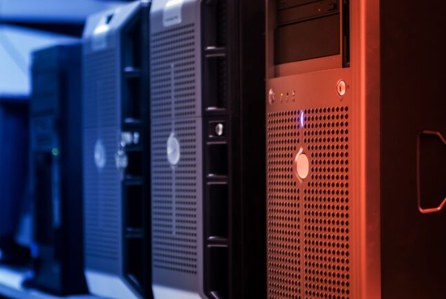 A row of server towers lit in blue and orange