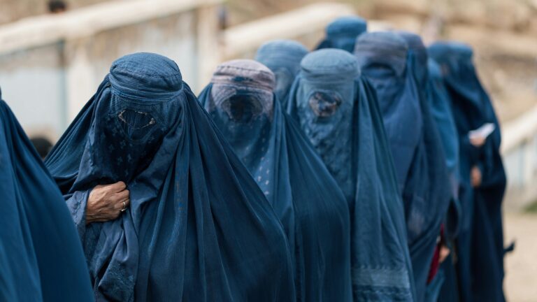 A group of women wearing blue burqas