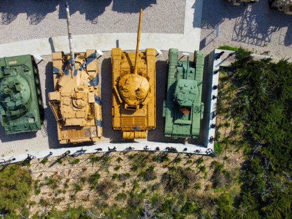 Aerial view of military tanks lined up in an outdoor facility