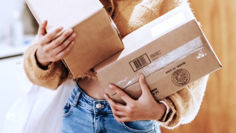 Close-up of a woman holding two cardboard parcels