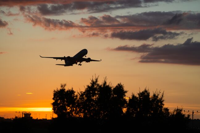 Aircraft taking off at sunset