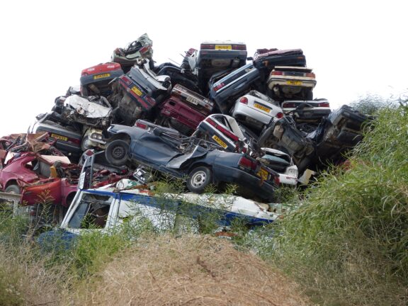 Pile of crushed end-of-life vehicles at a scrapyard