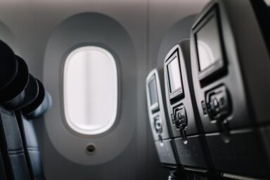 11:28Claude responded: Airplane seats and headrests viewed from the aisleAirplane seats and headrests viewed from the aisle