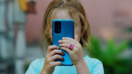Young girl looking at a smartphone screen