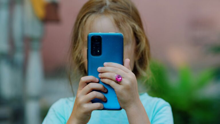 Young girl looking at a smartphone screen