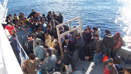 Migrants on a boat at the Italian coast