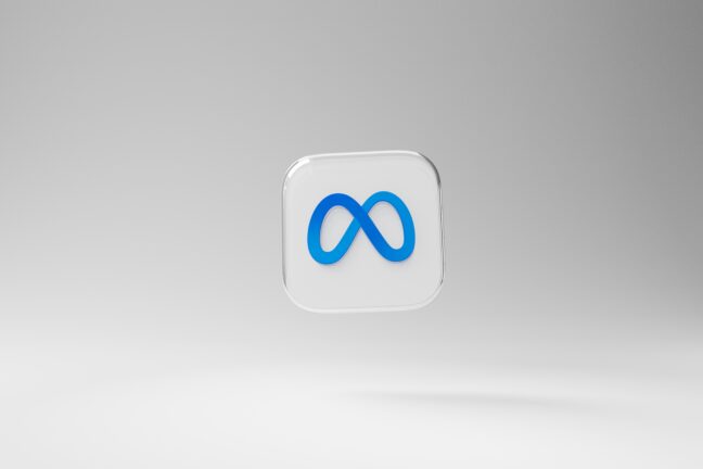 Meta's logo icon displayed on a glossy square tile against a grey background