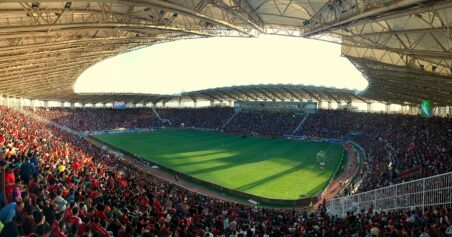 Football fans packed into a stadium stand