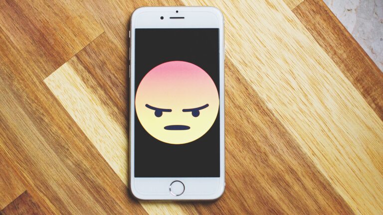 Smartphone screen showing a large angry emoji