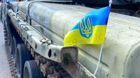 Close-up of a Ukrainian flag attached to the side of a tank