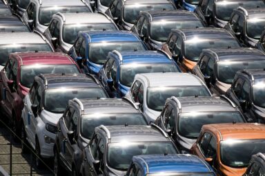 Rows of cars parked in a large outdoor storage lot, seen from above