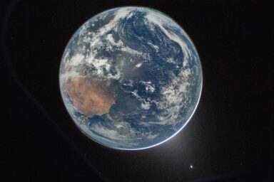 View of Earth from space showing continents through cloud cover