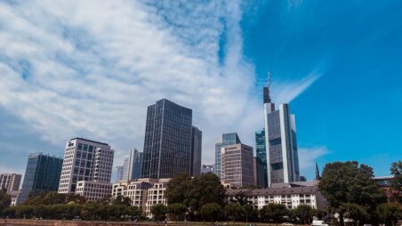 Frankfurt skyline with the Commerzbank Tower and financial district skyscrapers under a blue sky
