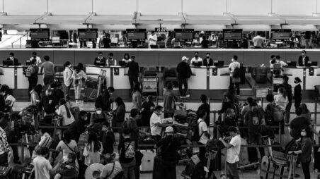 Travellers queuing at airport check-in counters