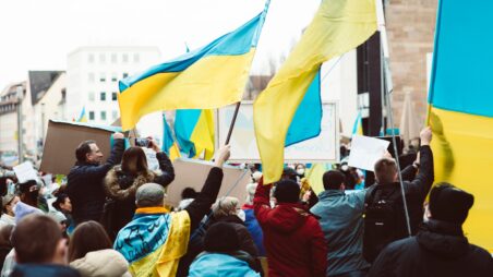 People holding Ukrainian flags during a public demonstration