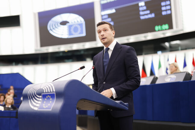 Jordan Bardella speaking at a podium during a European Parliament plenary session