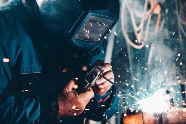 Welder wearing protective equipment