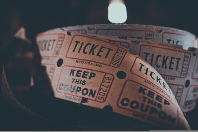 A roll of paper raffle-style tickets stamped 'Keep this coupon