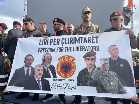 Kosovo Liberation Army veterans hold a banner reading "Freedom for the Liberators" with portraits of the four convicted men
